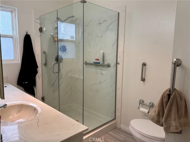 a bathroom with a sink toilet and shower