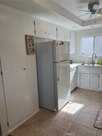 a utility room with cabinets washer and dryer
