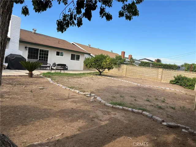 a view of a patio with table and chairs potted plants with swimming pool