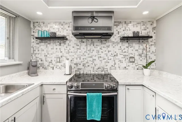 a kitchen with stainless steel appliances granite countertop a sink stove and cabinets
