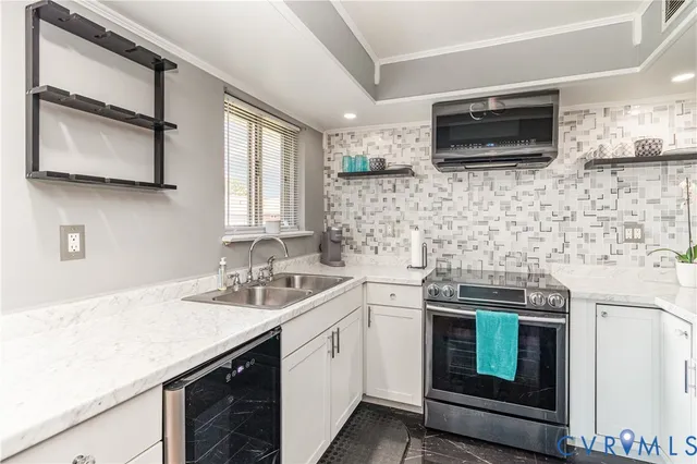 a kitchen with a sink stove and microwave