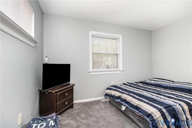 a bedroom with a bed and television