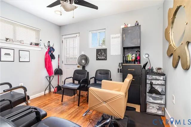 a living room with furniture a rug and gym equipment