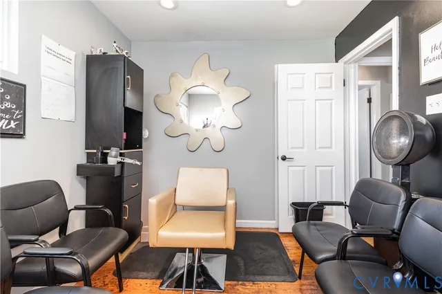 a living room with furniture a mirror and a lamp