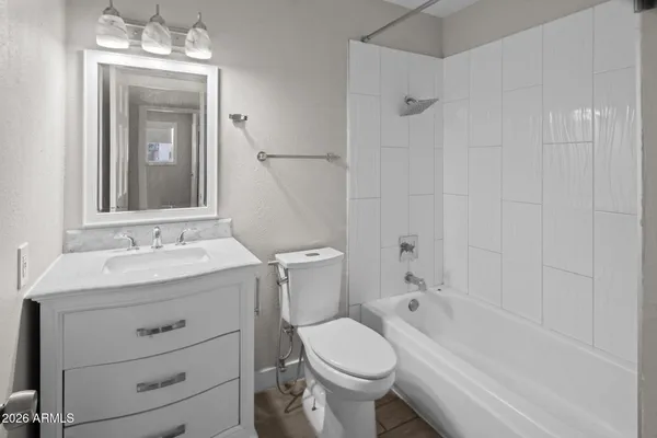 a bathroom with a sink toilet vanity and shower