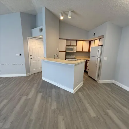 a kitchen with stainless steel appliances granite countertop a stove and a refrigerator
