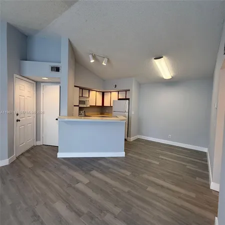 a view of kitchen with wooden floor