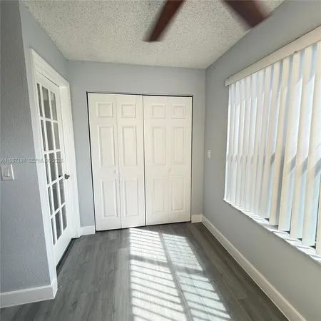 a view of a room with wooden floor and staircase