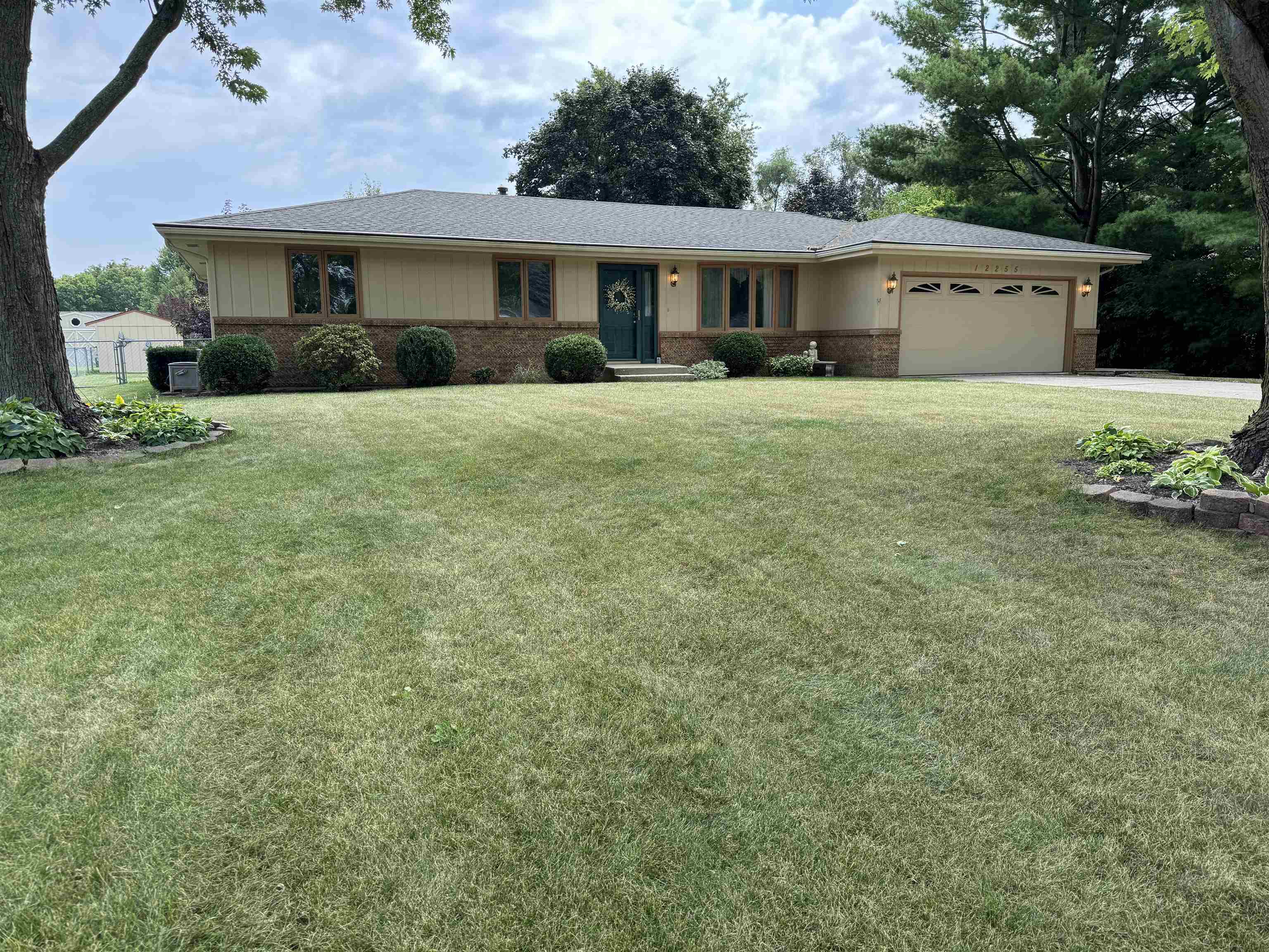 12255 Rae Ann Road Roscoe, IL 61073 - Photo 1 of 37 a front view of a house with a yard and garage