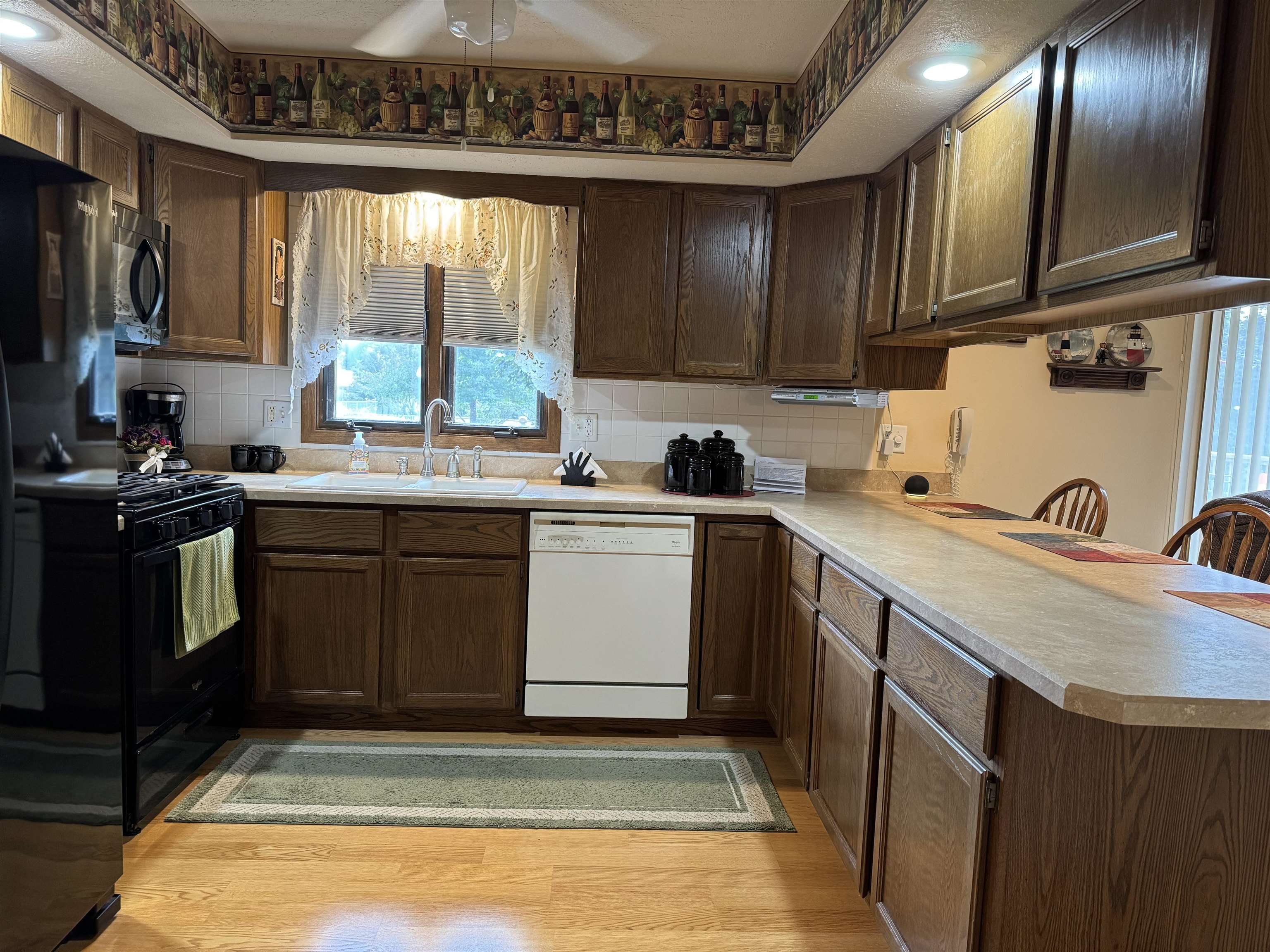 12255 Rae Ann Road Roscoe, IL 61073 - Photo 12 of 37 a kitchen with a sink stove and cabinets