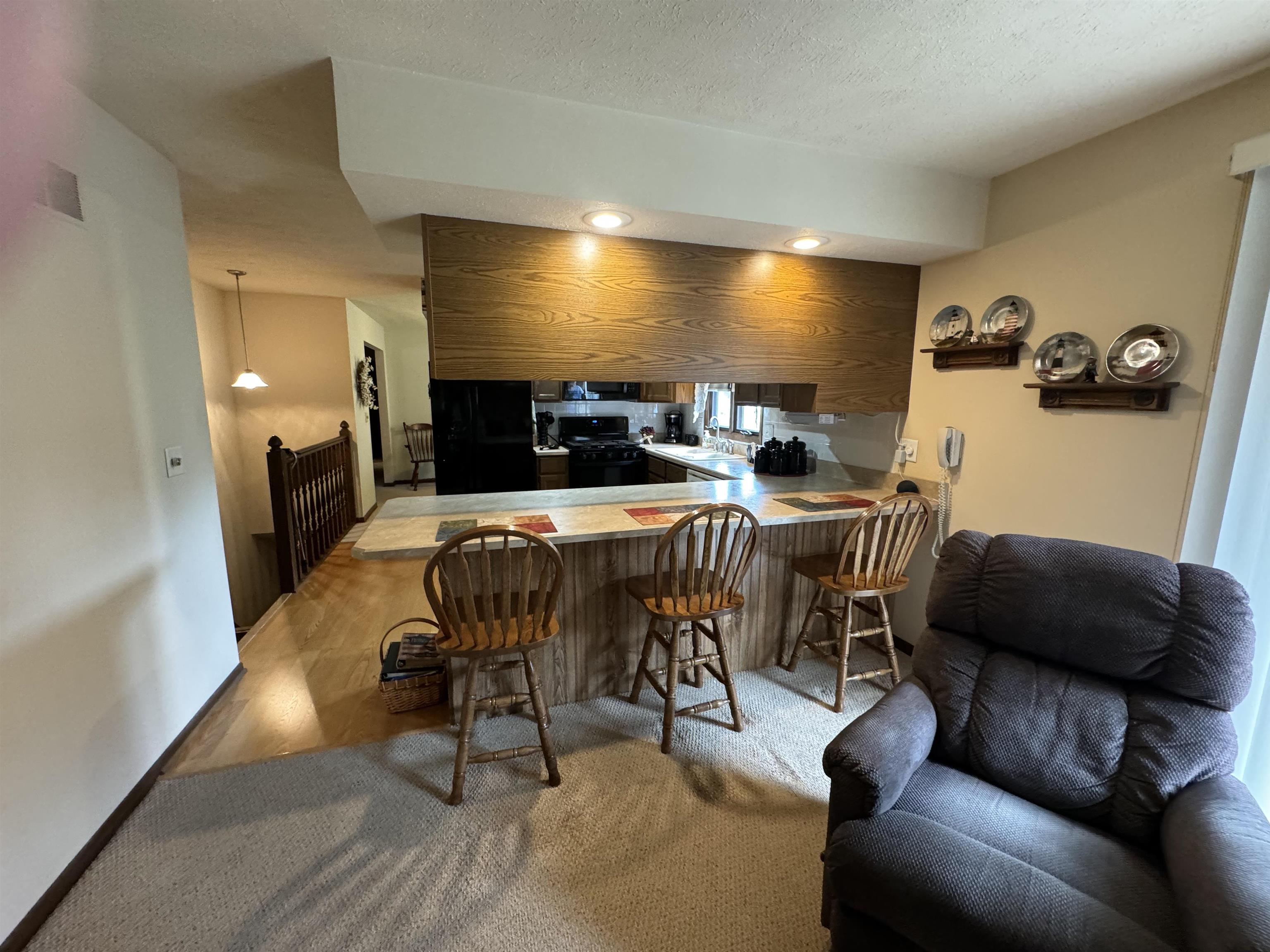 12255 Rae Ann Road Roscoe, IL 61073 - Photo 13 of 37 a dining room with furniture and a flat screen tv