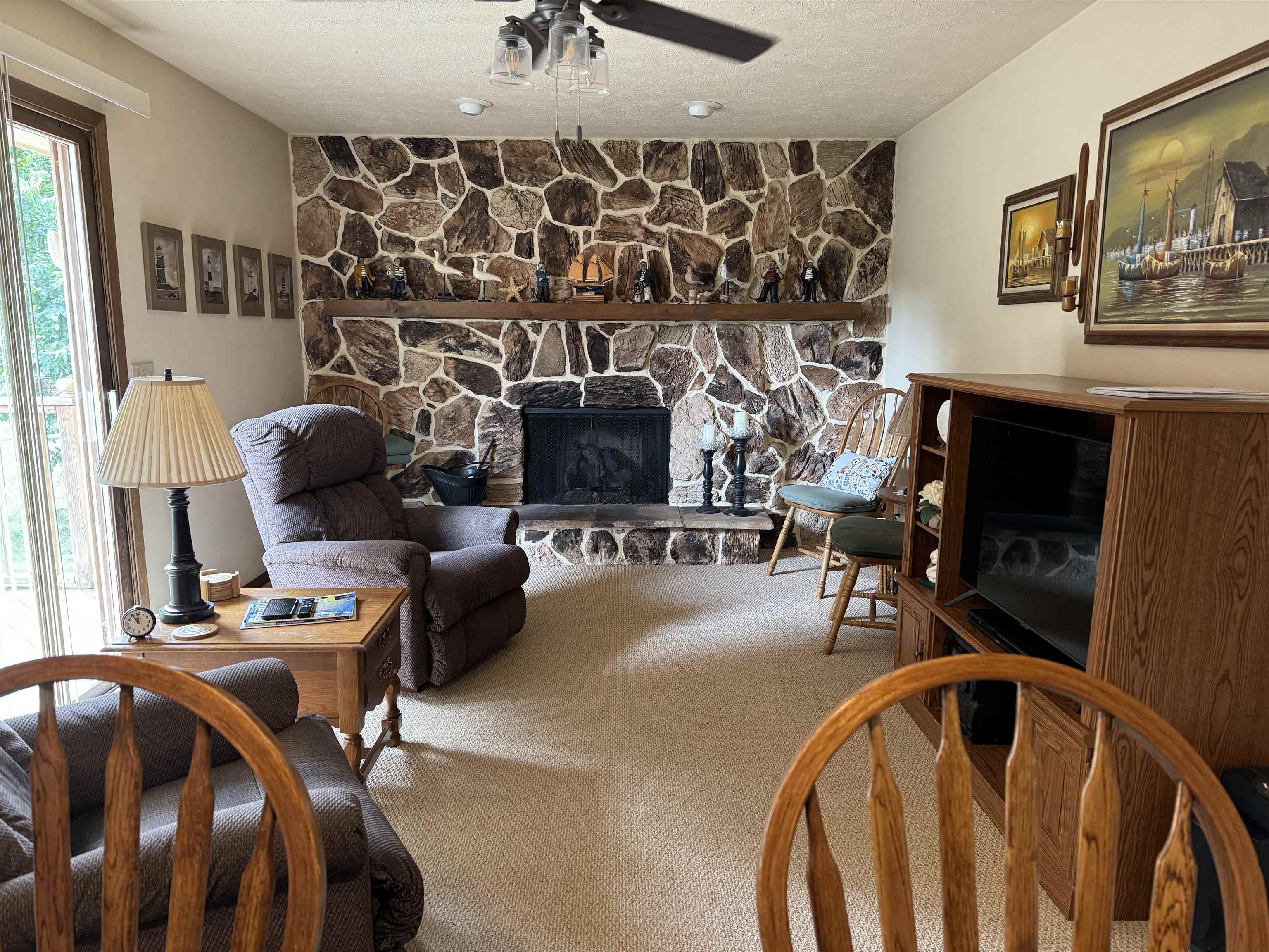 12255 Rae Ann Road Roscoe, IL 61073 - Photo 14 of 37 a living room with furniture and a fireplace