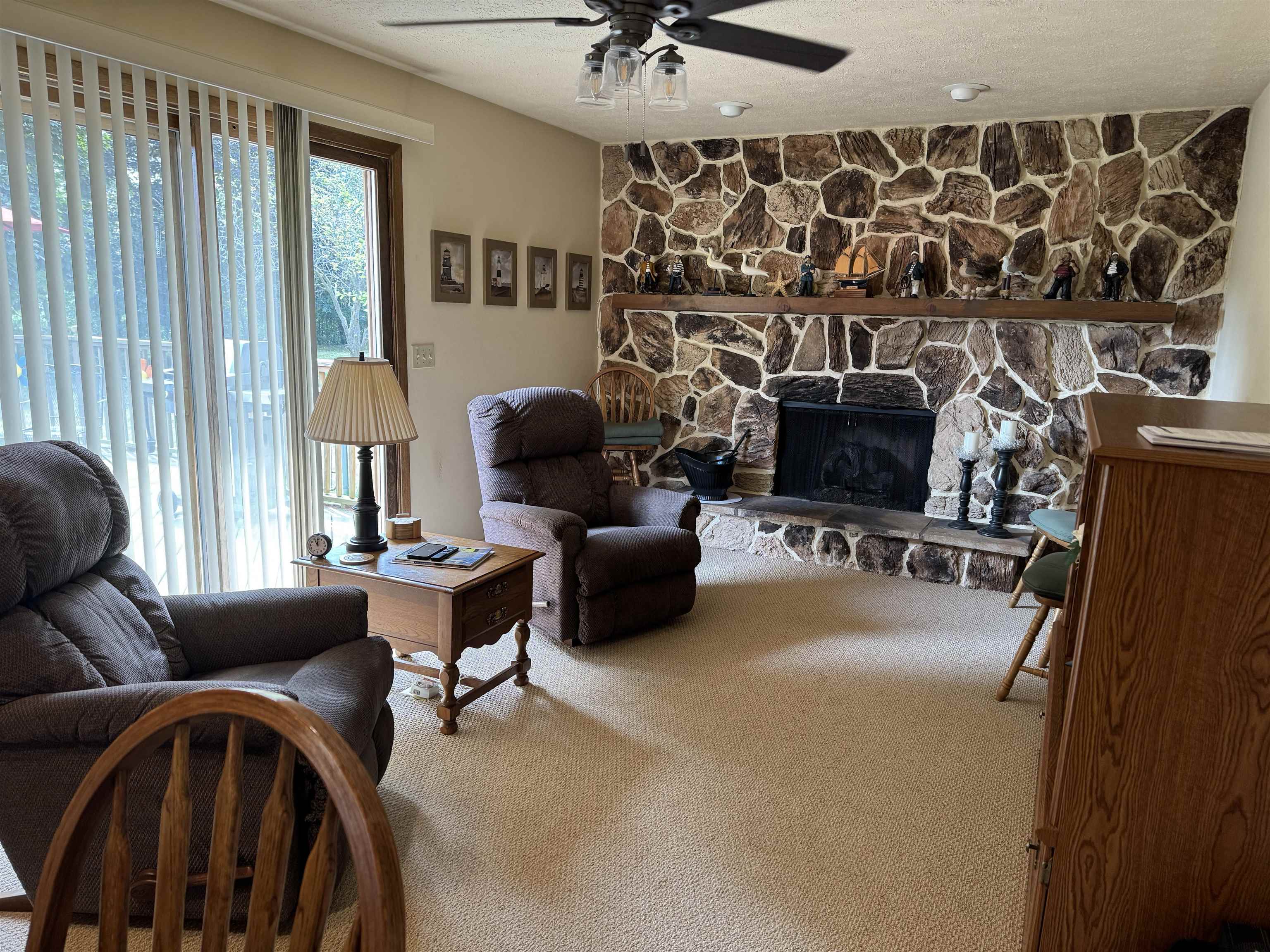 12255 Rae Ann Road Roscoe, IL 61073 - Photo 15 of 37 a living room with furniture a fireplace and a flat screen tv