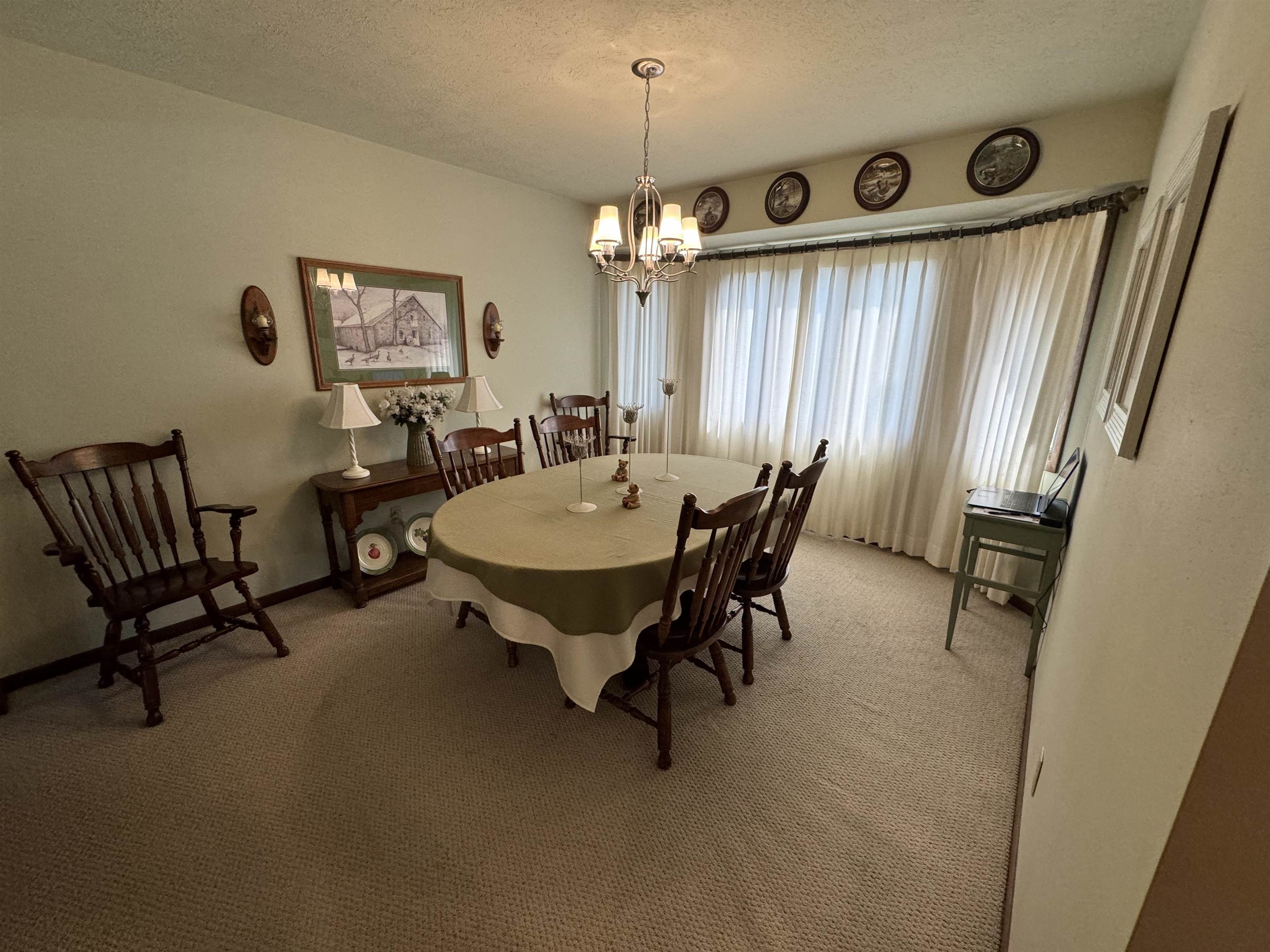 12255 Rae Ann Road Roscoe, IL 61073 - Photo 18 of 37 a view of a dining room with furniture and a chandelier