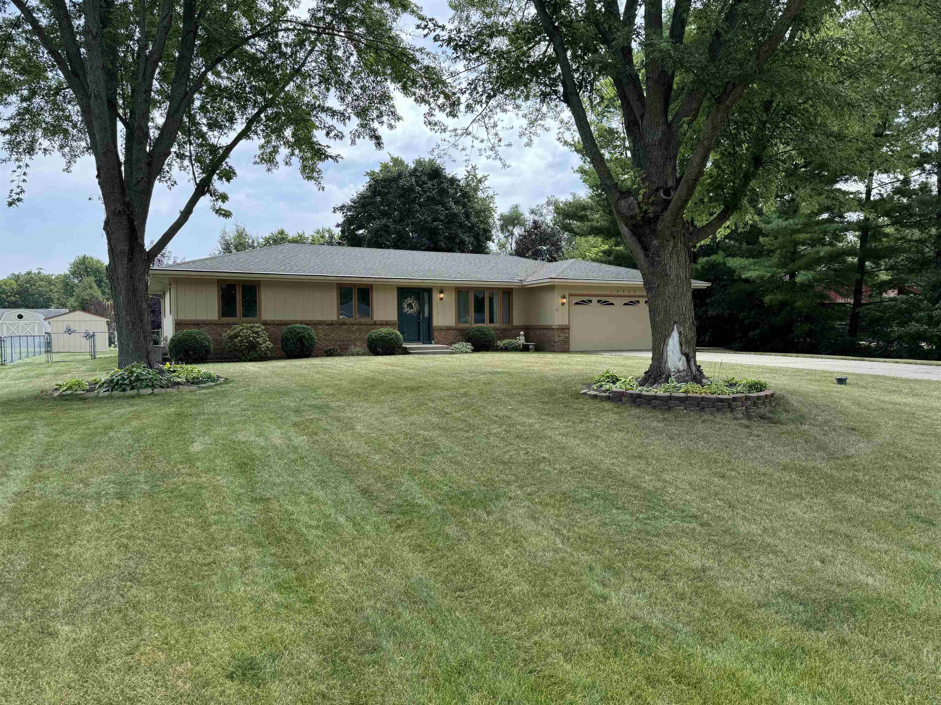 12255 Rae Ann Road Roscoe, IL 61073 - Photo 2 of 37 a house with trees in front of it