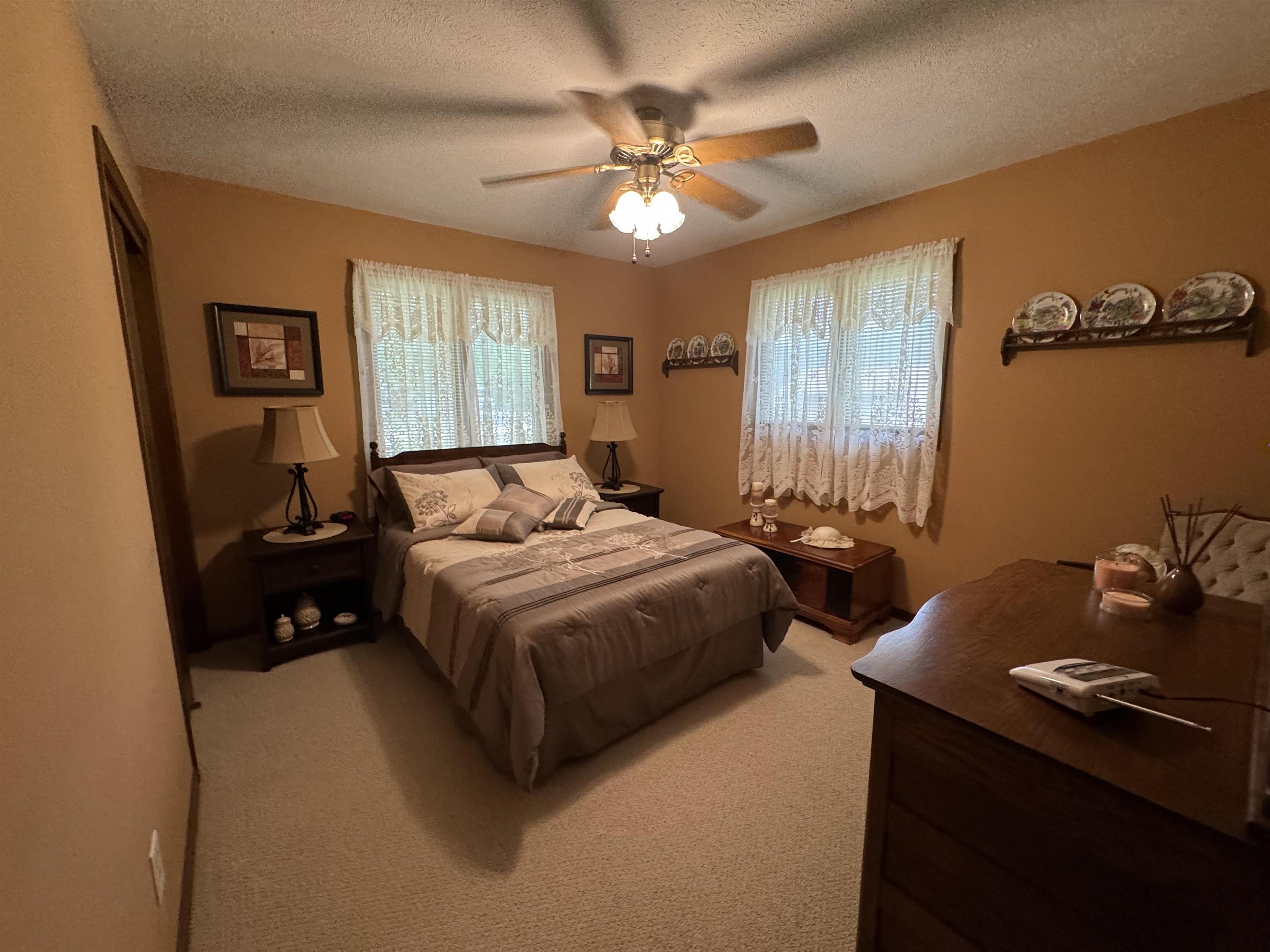 12255 Rae Ann Road Roscoe, IL 61073 - Photo 23 of 37 a bedroom with a bed and a chandelier