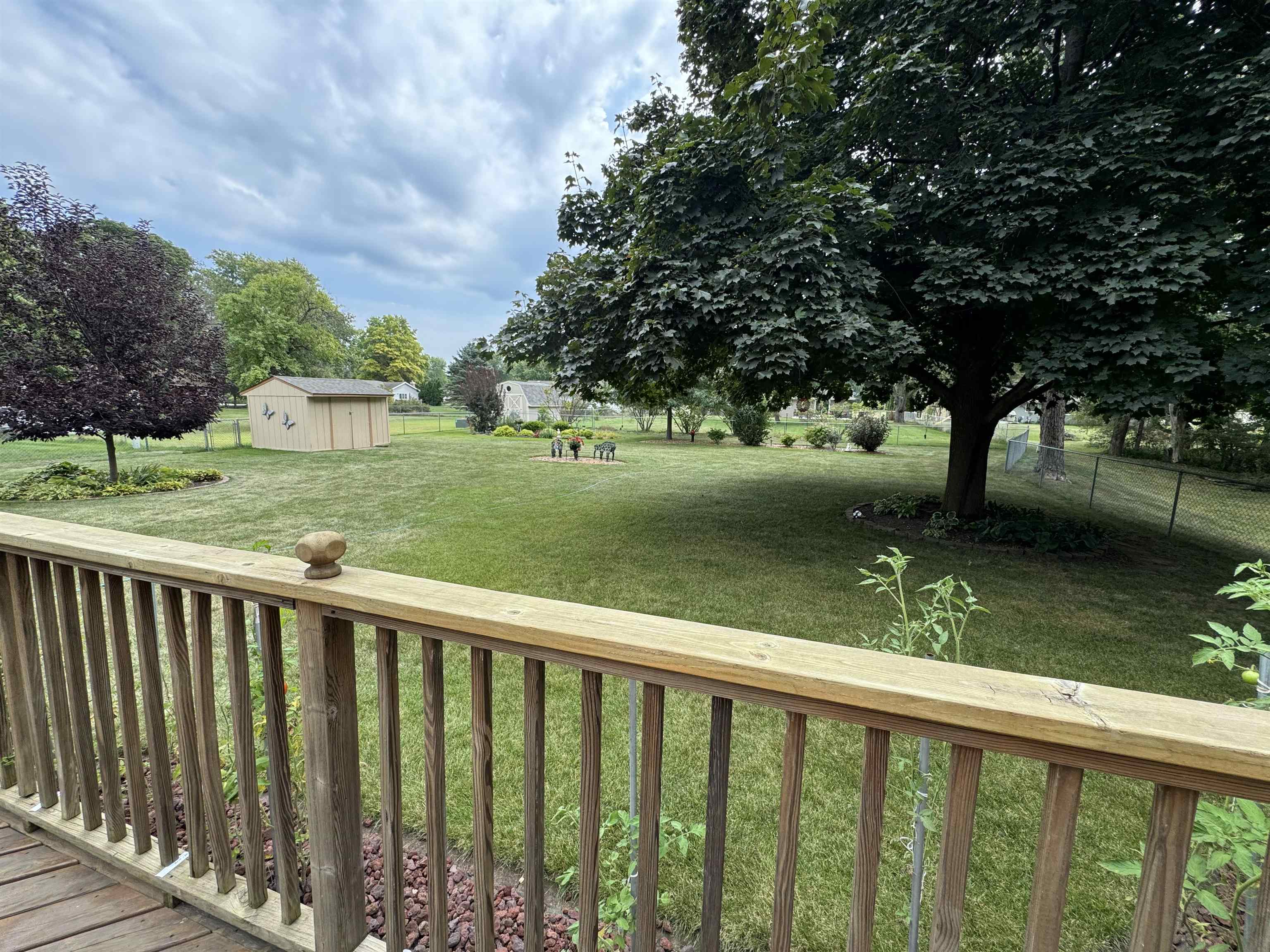 12255 Rae Ann Road Roscoe, IL 61073 - Photo 33 of 37 a view of a wooden deck and a yard with wooden fence