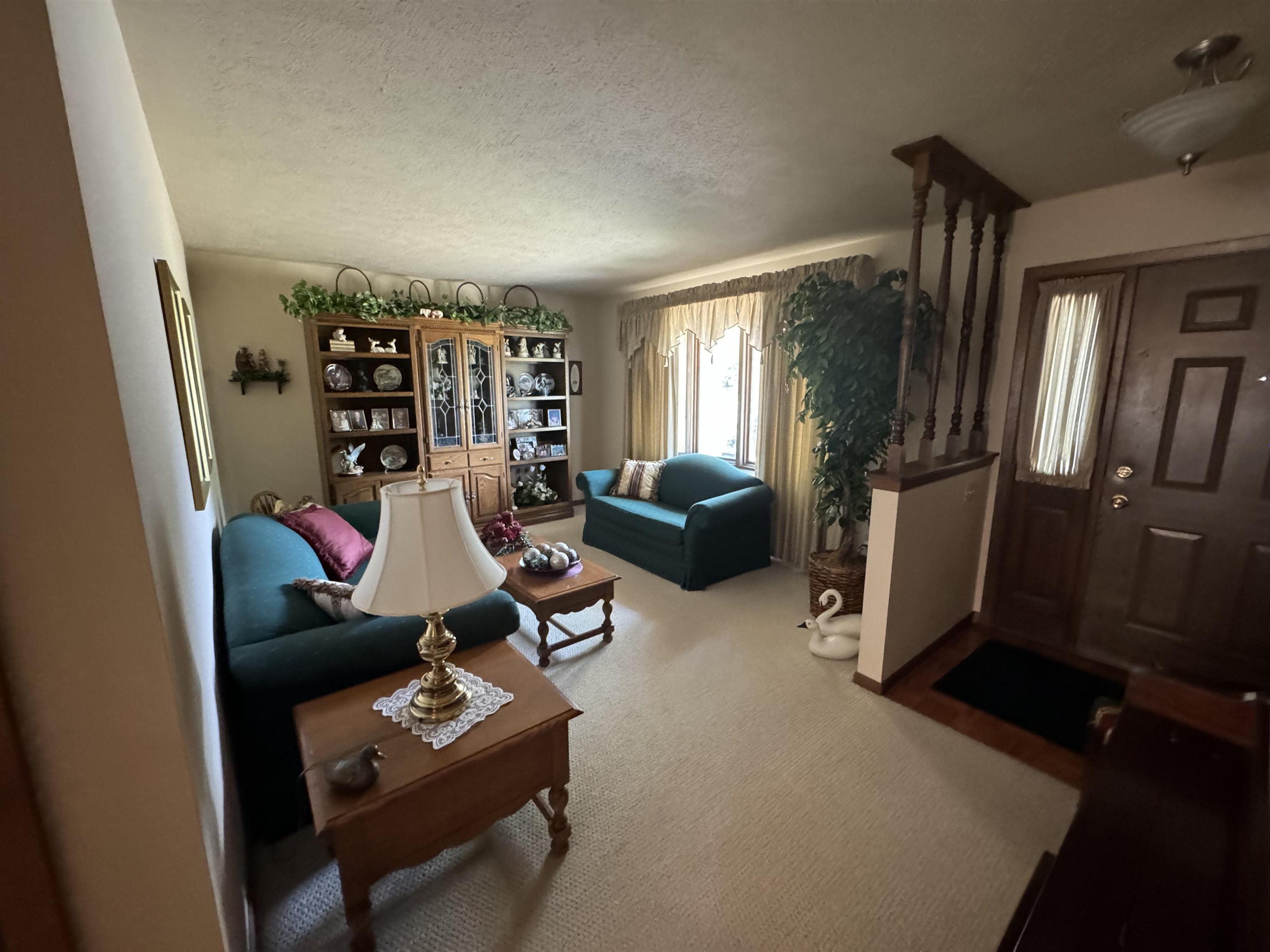 12255 Rae Ann Road Roscoe, IL 61073 - Photo 4 of 37 a living room with furniture a window and gym equipment