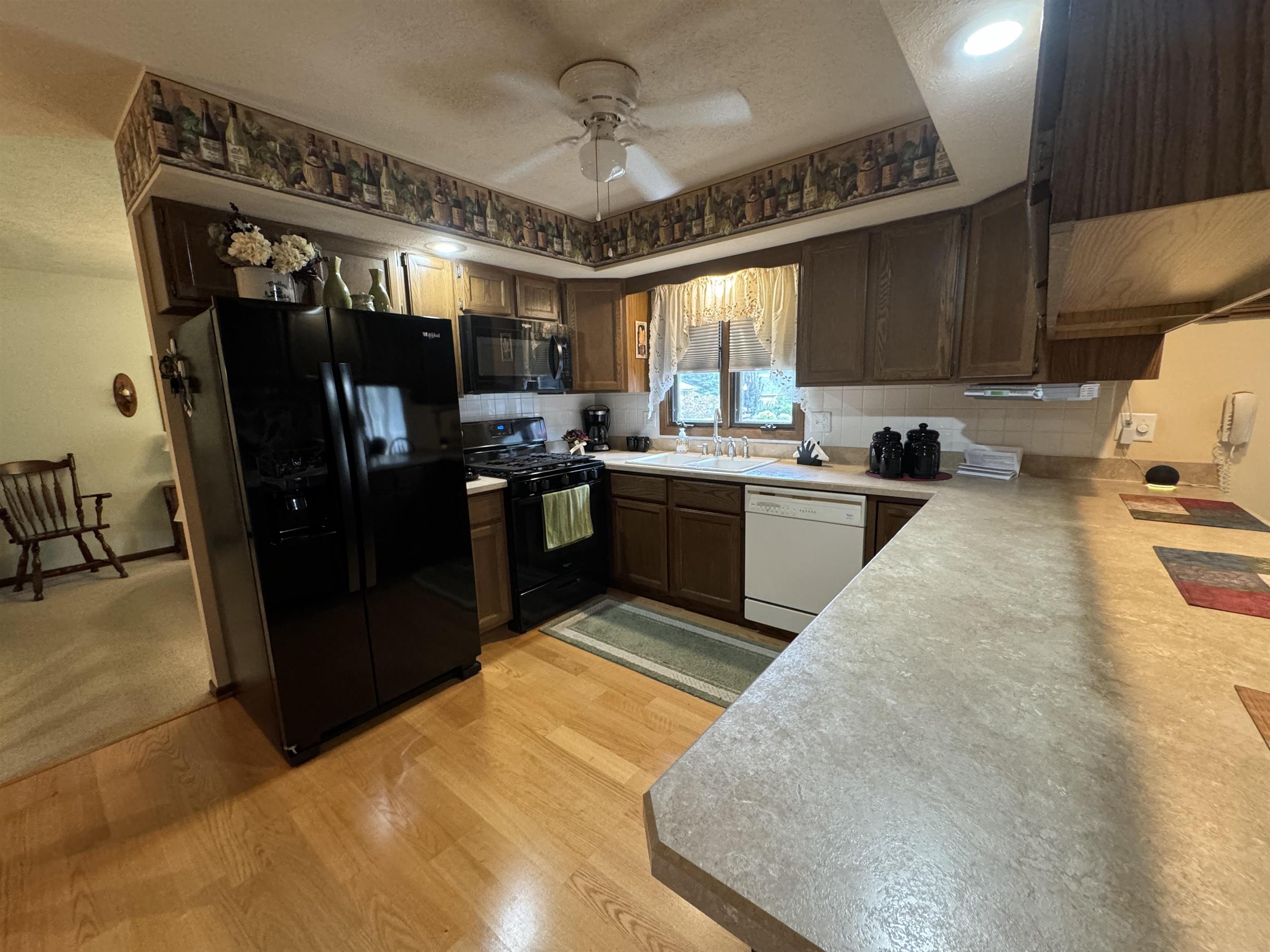 12255 Rae Ann Road Roscoe, IL 61073 - Photo 7 of 37 a kitchen with refrigerator and window