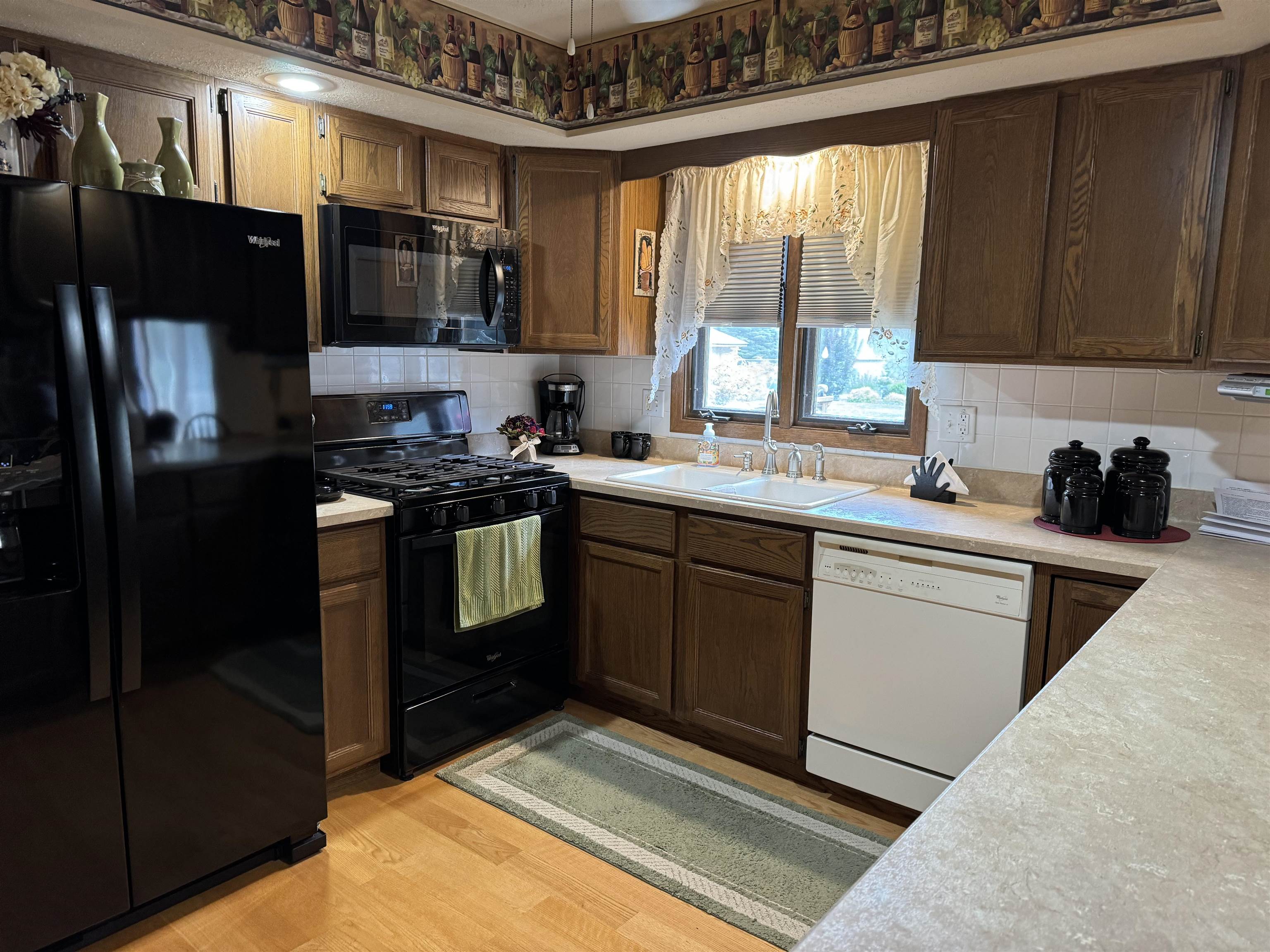 12255 Rae Ann Road Roscoe, IL 61073 - Photo 8 of 37 a kitchen with a sink stove and microwave