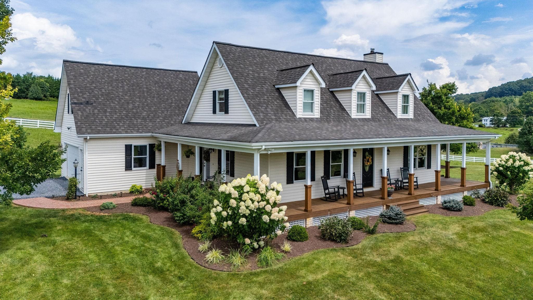 a front view of a house with sitting space and garden