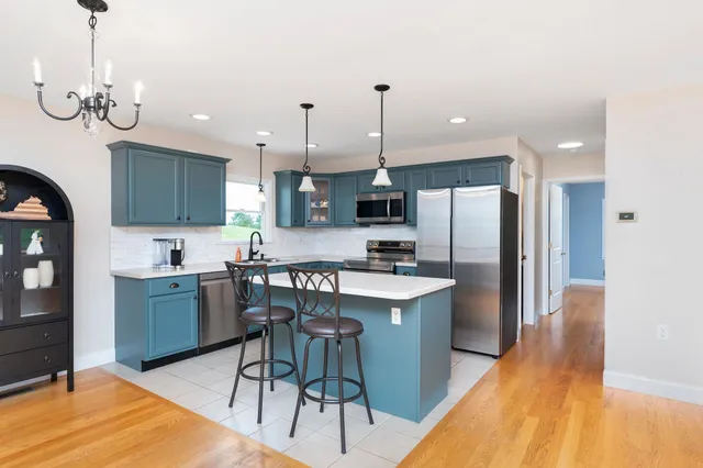 a bathroom with a sink a toilet and a large mirror