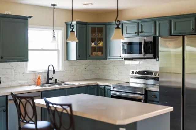 an aerial view of a house with a yard