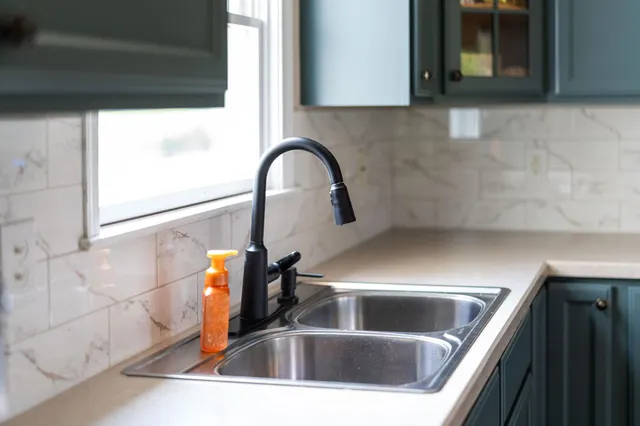 an aerial view of a house with a yard and lake view