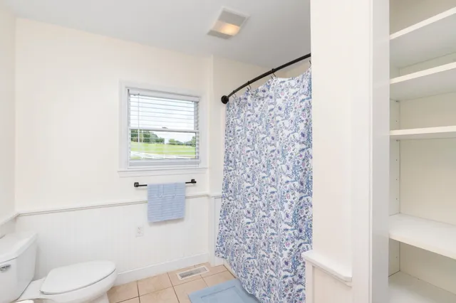 an aerial view of a house with garden space and a swimming pool