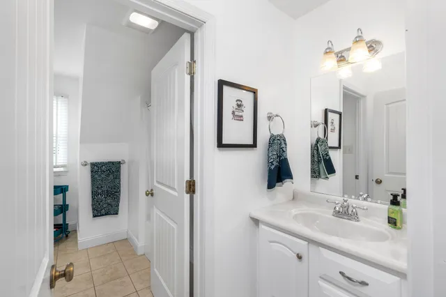a view of a wooden house with a big yard and large trees