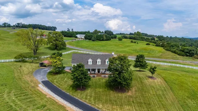 a view of a house with garden and a sitting area