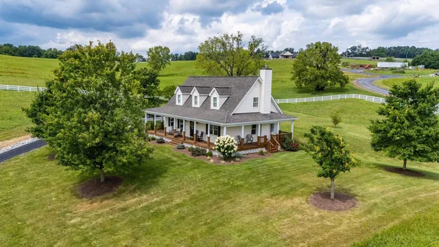 a front view of a house with swimming pool having outdoor seating