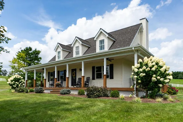 a view of a patio with chairs and floor to ceiling window