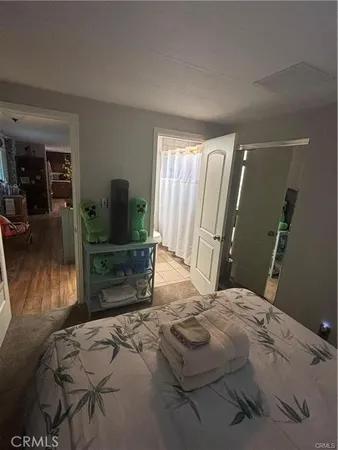 a bedroom with a bed and flat screen tv