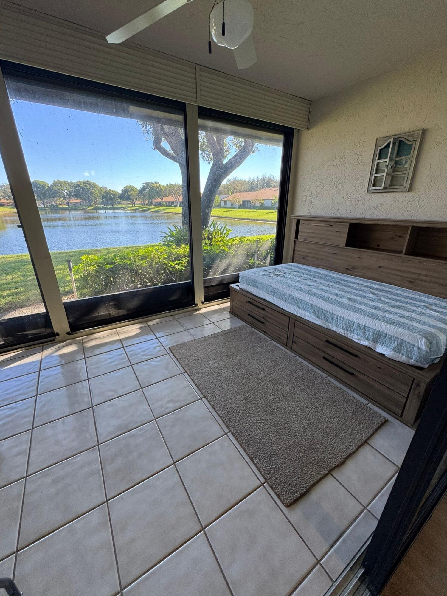 18560 Sunburst Lane, Unit D Boca Raton, FL 33496 - Photo 17 of 28 a view of a living room and floor to ceiling window