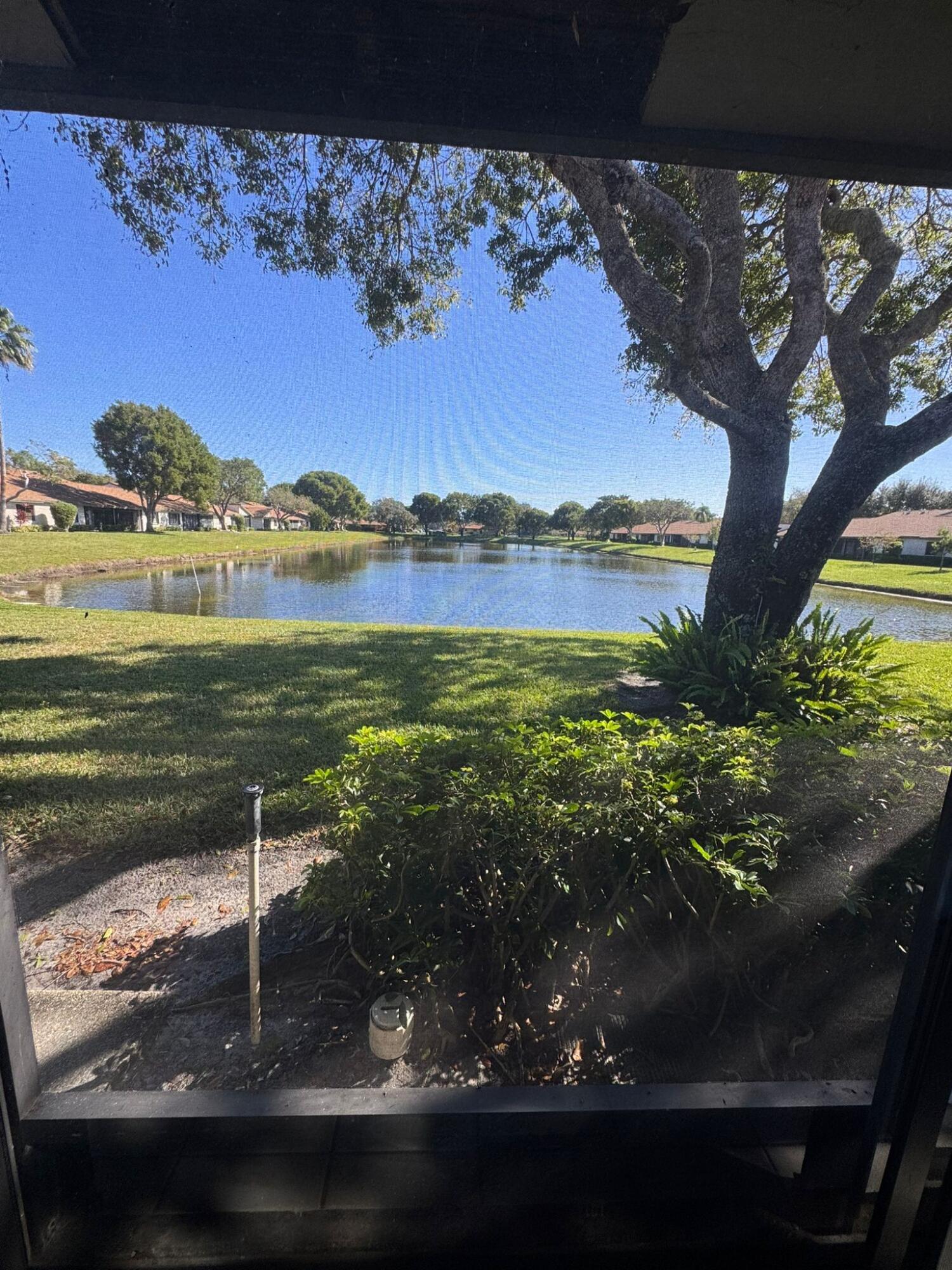18560 Sunburst Lane, Unit D Boca Raton, FL 33496 - Photo 3 of 28 a view of a lake from a balcony