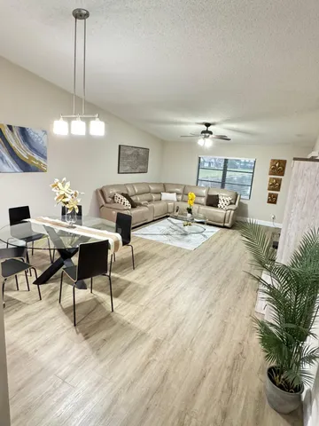a living room with furniture and a chandelier