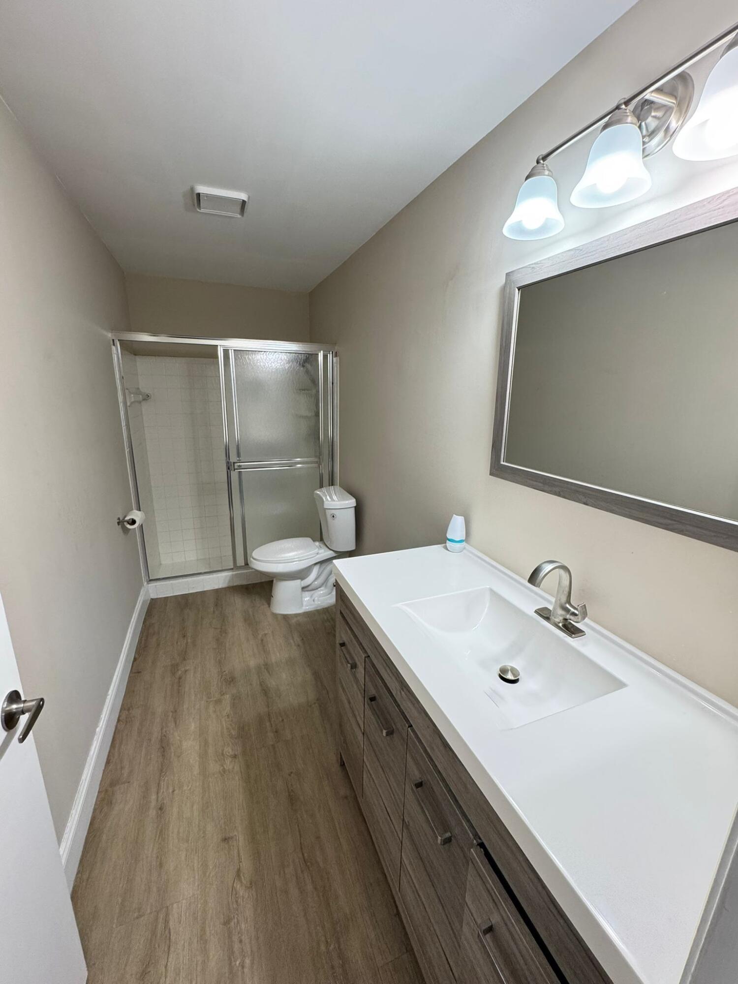 18560 Sunburst Lane, Unit D Boca Raton, FL 33496 - Photo 10 of 28 a bathroom with a sink and mirror