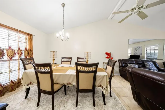 a view of a dining room with furniture and a chandelier