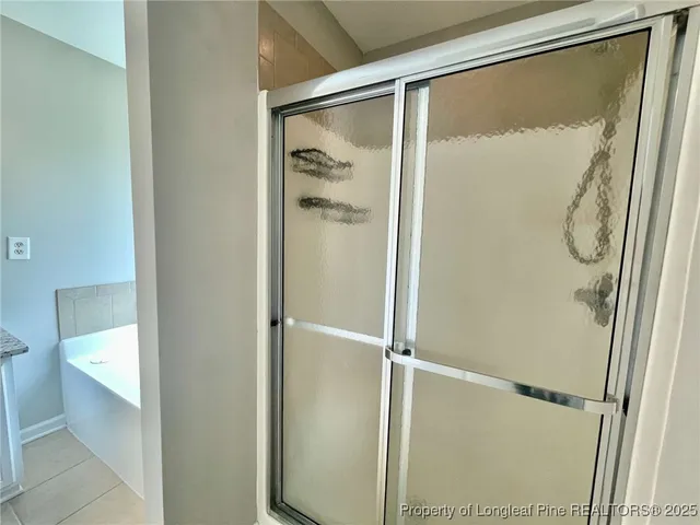 a bathroom with a glass shower door