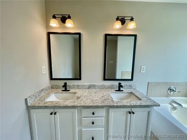 a bathroom with 2 sink and a mirror