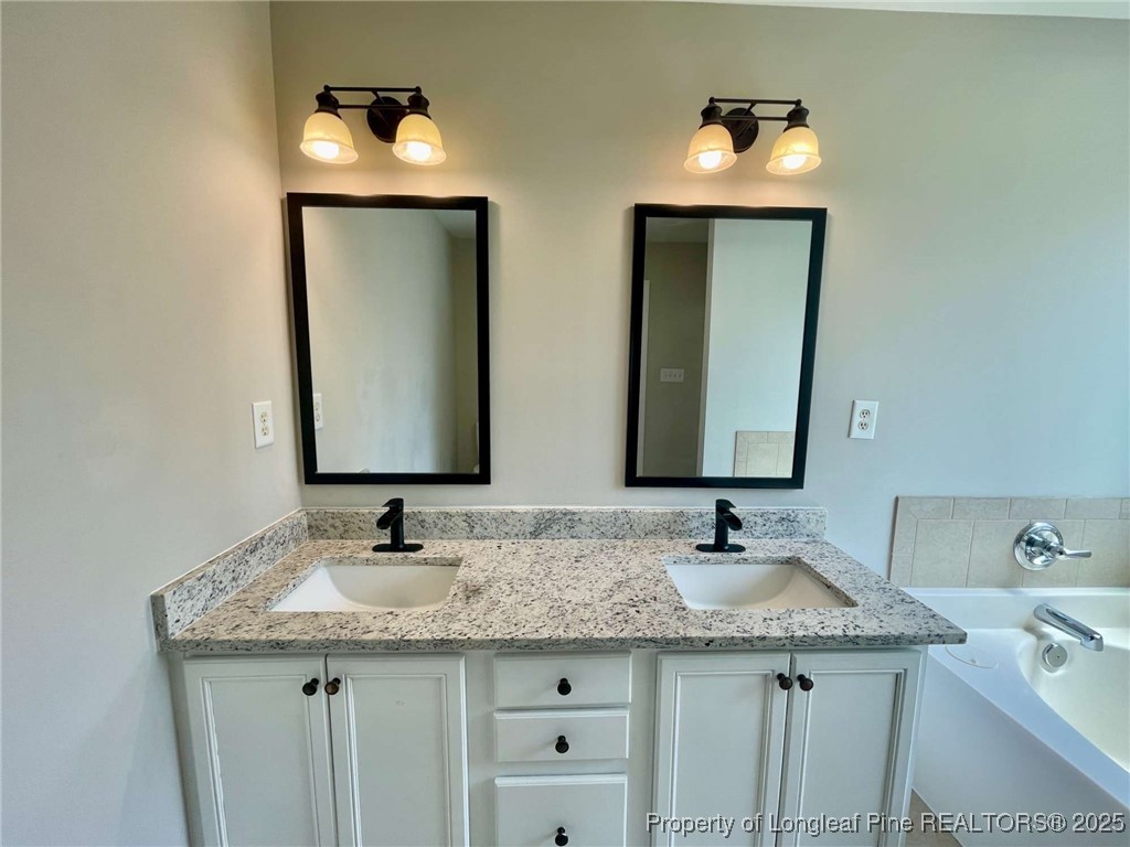 216 Cobblestone Drive Spring Lake, NC 28390 - Photo 12 of 30 a bathroom with 2 sink and a mirror