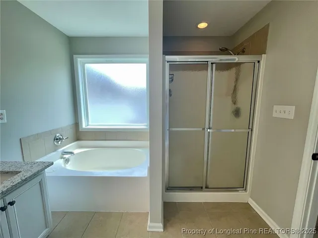 a bathroom with a shower and a sink