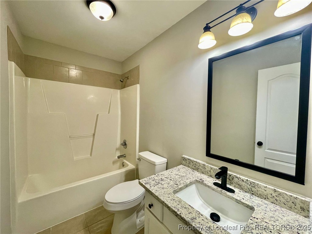 216 Cobblestone Drive Spring Lake, NC 28390 - Photo 15 of 30 a bathroom with a sink a toilet and shower a mirror