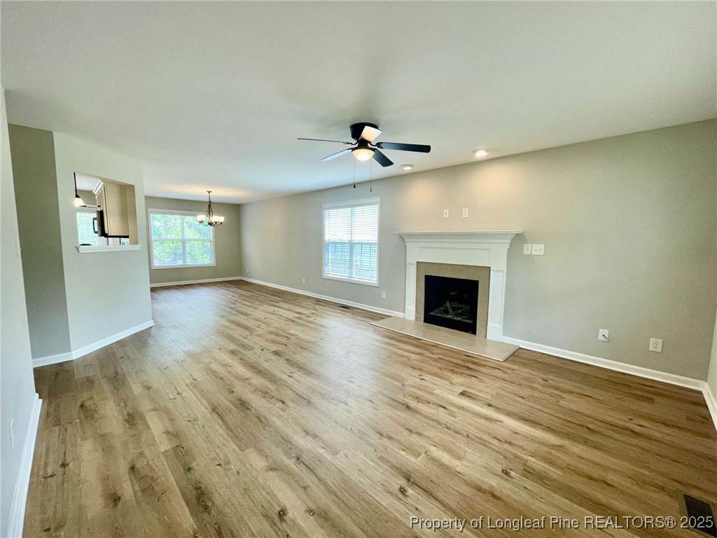 216 Cobblestone Drive Spring Lake, NC 28390 - Photo 18 of 30 a view of an empty room with wooden floor and a fireplace