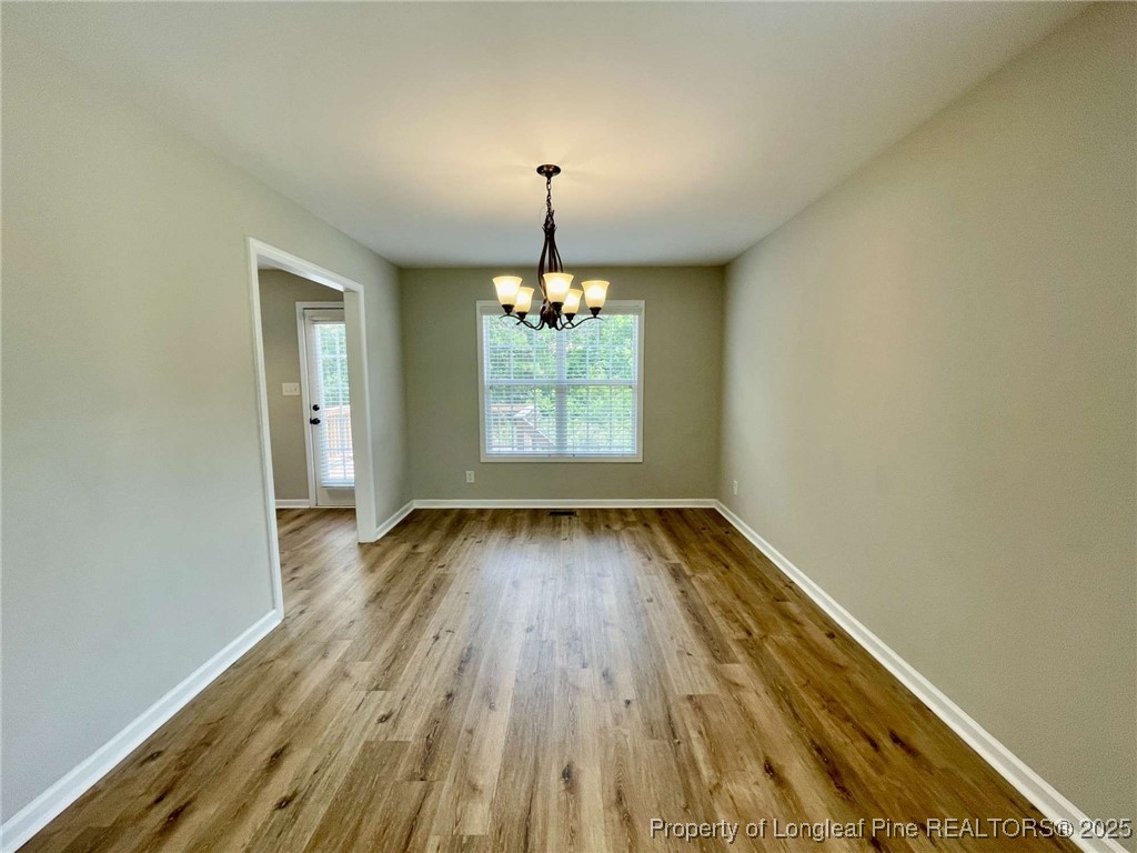 216 Cobblestone Drive Spring Lake, NC 28390 - Photo 20 of 30 wooden floor in an empty room with a window