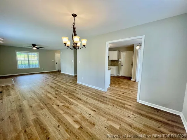 a view of a room with wooden floor