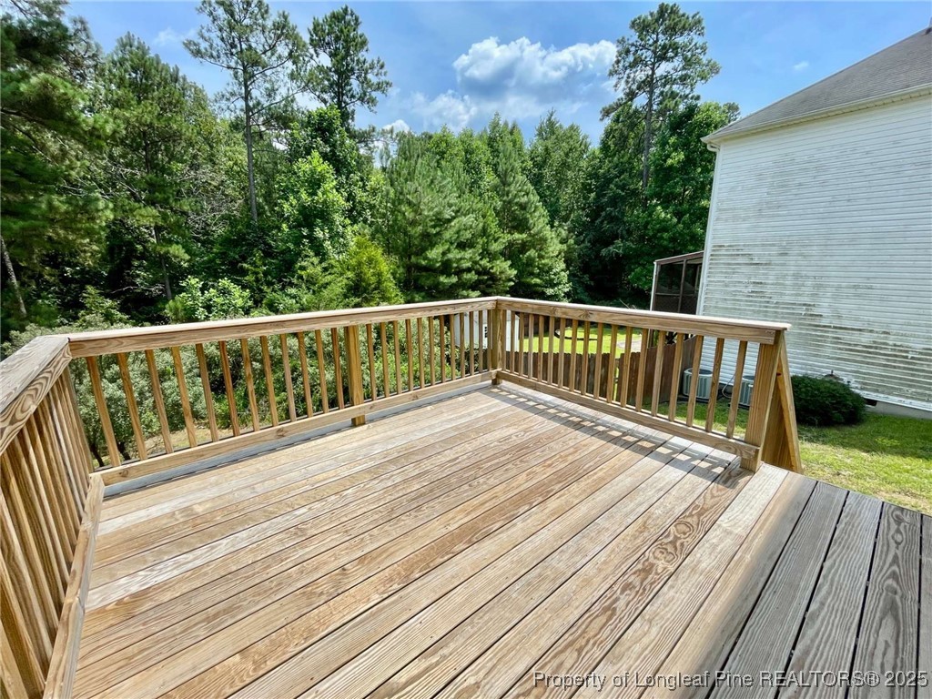 216 Cobblestone Drive Spring Lake, NC 28390 - Photo 29 of 30 a view of deck with two chairs and wooden floor