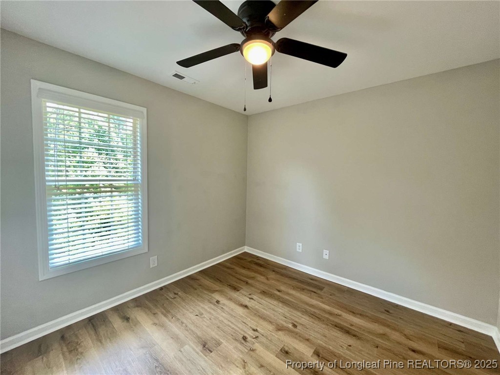 216 Cobblestone Drive Spring Lake, NC 28390 - Photo 4 of 30 wooden floor in an empty room with a window