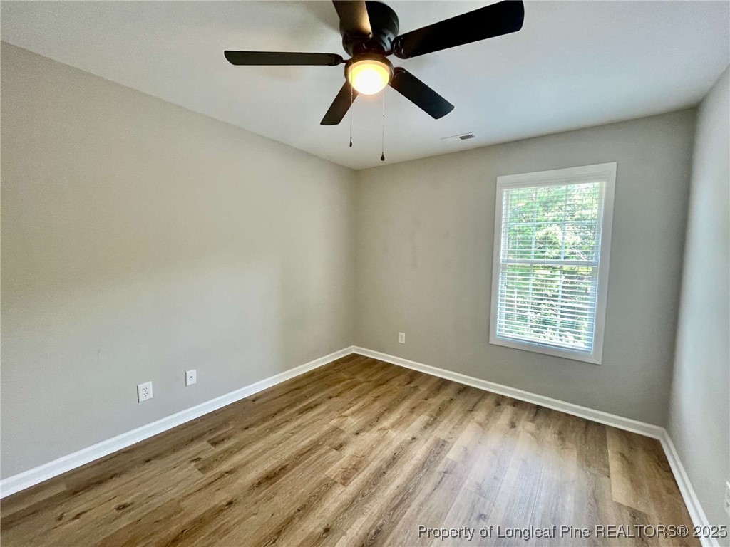 216 Cobblestone Drive Spring Lake, NC 28390 - Photo 6 of 30 an empty room with a window and a ceiling fan